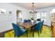 Elegant dining room with a charming table, blue chairs, and a statement chandelier at 2121 Winter St, Charlotte, NC 28205