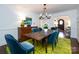 Bright dining room with a wooden table, blue chairs and a view to the living room at 2121 Winter St, Charlotte, NC 28205