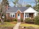 Brick home with a light teal door, landscaped yard, and a covered porch at 2121 Winter St, Charlotte, NC 28205