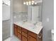 Double vanity bathroom with wood cabinets and updated flooring at 2139 Mallard Green Pl, Charlotte, NC 28262