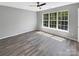 Bright bedroom with wood-look flooring and large window at 2139 Mallard Green Pl, Charlotte, NC 28262