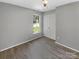 Bright bedroom with gray walls, wood-look floors, and double doors at 2139 Mallard Green Pl, Charlotte, NC 28262