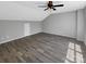 Spacious bonus room with wood-look flooring and ceiling fan at 2139 Mallard Green Pl, Charlotte, NC 28262