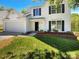 Two-story house with white siding, a large garage and a landscaped front yard at 2139 Mallard Green Pl, Charlotte, NC 28262