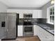 Updated kitchen featuring stainless steel appliances and granite countertops at 2139 Mallard Green Pl, Charlotte, NC 28262