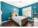 Charming blue bedroom with a decorative wall piece, wood furniture, and natural light at 223 Blossom Ridge Dr # 137, Mooresville, NC 28117