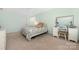 Bedroom with a ceiling fan, patterned bed, and a vanity with mirror at 223 Blossom Ridge Dr # 137, Mooresville, NC 28117