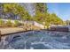 Inviting hot tub on a deck with a beautiful view of a landscaped backyard and a white picket fence at 223 Blossom Ridge Dr # 137, Mooresville, NC 28117