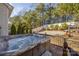 Luxurious hot tub on a wooden deck, surrounded by lush greenery and landscaping in the backyard at 223 Blossom Ridge Dr # 137, Mooresville, NC 28117