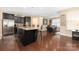 Open kitchen featuring a large island with granite countertops and black cabinets at 223 Blossom Ridge Dr # 137, Mooresville, NC 28117