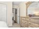 Bright bedroom showcasing neutral paint, dresser with mirror, and views into hall and another bedroom at 2710 Redbud Ln, Fort Mill, SC 29715