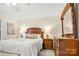 Inviting bedroom with a wooden headboard, coordinated furniture, and soft, warm lighting at 2710 Redbud Ln, Fort Mill, SC 29715