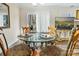 Dining area with a glass table and view through glass doors to the back at 2710 Redbud Ln, Fort Mill, SC 29715