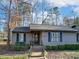 Charming single-story home featuring gray siding, dark shutters, and a well-manicured front yard at 2710 Redbud Ln, Fort Mill, SC 29715