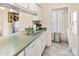 Kitchen area with stainless sink, white cabinets and appliances, and tile flooring at 2710 Redbud Ln, Fort Mill, SC 29715