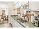 The kitchen overlooks dining and living areas with a double sink and breakfast bar at 2710 Redbud Ln, Fort Mill, SC 29715