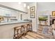 Bright, open kitchen and bar area leading to a cozy living room with hardwood floors and neutral paint at 2710 Redbud Ln, Fort Mill, SC 29715