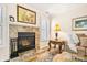 Living room featuring a stone fireplace, hardwood floors, and a cozy seating area at 2710 Redbud Ln, Fort Mill, SC 29715