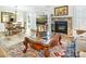 Living room featuring stone fireplace, neutral colors, and view to the dining area at 2710 Redbud Ln, Fort Mill, SC 29715