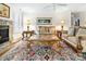 Inviting living room features a stone fireplace, plush seating, and a stylish, colorful area rug at 2710 Redbud Ln, Fort Mill, SC 29715