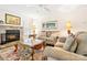 Warm and inviting living room with a stone fireplace, plush furniture, and natural light at 2710 Redbud Ln, Fort Mill, SC 29715