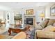 Well-lit living room featuring a stone fireplace and comfortable seating at 2710 Redbud Ln, Fort Mill, SC 29715