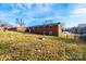 Expansive backyard featuring a well-maintained lawn and a classic brick building under a bright blue sky at 2745 33Rd Ne Ave, Hickory, NC 28601