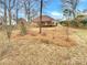 Large backyard with mature trees and a partially fenced area at 3013 Tiffany Dr, Monroe, NC 28110