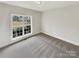 Well-lit bedroom featuring a large window and neutral walls at 3013 Tiffany Dr, Monroe, NC 28110