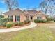 Brick house with a brown roof, landscaping, and walkway at 3013 Tiffany Dr, Monroe, NC 28110