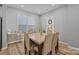 Dining room with marble table and six beige chairs at 3089 Virginia Trail Ct, Fort Mill, SC 29715