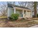 Inviting home featuring a covered porch with classic columns and natural landscaping at 309 Lloyd St, Salisbury, NC 28144