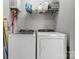 Bright laundry room features modern Whirlpool washer and dryer, plus upper storage shelf for supplies at 309 Lloyd St, Salisbury, NC 28144