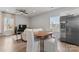 Open floor plan showcasing dining area with table, chairs and a stainless steel refrigerator adjacent to living room at 309 Lloyd St, Salisbury, NC 28144