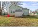 Exterior shot of the home's rear, showing its light-green siding, shed, and backyard at 309 Lloyd St, Salisbury, NC 28144