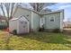 Back of home featuring light-green siding, a convenient shed for storage, and a well-maintained lawn at 309 Lloyd St, Salisbury, NC 28144