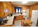 Kitchen with wood cabinets, white appliances, and tiled backsplash at 315 S Hill St, Gastonia, NC 28052