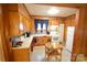 Kitchen with wood cabinets, white appliances, and small table at 315 S Hill St, Gastonia, NC 28052