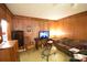 Living room with wood paneling, couch, and vintage furniture at 315 S Hill St, Gastonia, NC 28052