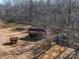 Cabin nestled among bare trees, with outbuildings in the surrounding landscape at 3609 Shillinglaw Rd, Sharon, SC 29742