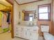 Bathroom featuring a white vanity, a medicine cabinet, a window, floral wallpaper and a toilet at 3609 Shillinglaw Rd, Sharon, SC 29742