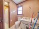 Bathroom featuring wood paneling, a single sink vanity, and a separate toilet room at 3609 Shillinglaw Rd, Sharon, SC 29742