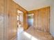 Image of a bedroom under construction with exposed framing, a bathroom, hardwood floors, and wood paneling at 3609 Shillinglaw Rd, Sharon, SC 29742