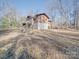 Side view of the cabin showing outdoor deck and wooded surroundings in winter at 3609 Shillinglaw Rd, Sharon, SC 29742