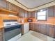 Kitchen featuring wood cabinets, orange countertops, white appliances, and a window view at 3609 Shillinglaw Rd, Sharon, SC 29742