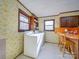 Bright laundry room featuring a washer, a dryer, wallpaper, and a small breakfast nook at 3609 Shillinglaw Rd, Sharon, SC 29742