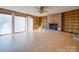 Living room with wood floors, ceiling fan, brick fireplace, and a built-in bookcase at 3609 Shillinglaw Rd, Sharon, SC 29742