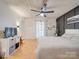 A modern main bedroom featuring a ceiling fan, wood floors, white paneled walls and a decorative dark accent wall at 3609 Shillinglaw Rd, Sharon, SC 29742