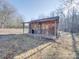 Rustic outbuilding on the property with covered porch surrounded by bare trees at 3609 Shillinglaw Rd, Sharon, SC 29742