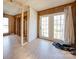 An unfurnished room with natural light through white-framed French doors, hardwood floors and wood paneling at 3609 Shillinglaw Rd, Sharon, SC 29742